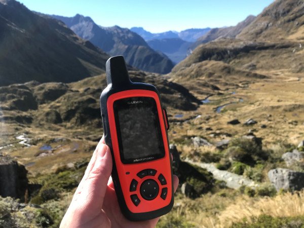 Range of rugged handheld and wearable lone worker safety devices alongside a smartphone