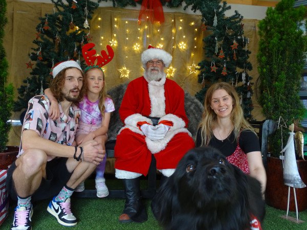 Stephen and his family meeting Santa during the festive Christmas season