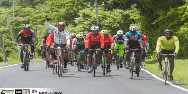 Cyclists crossing the finish line at Icacos Point on the Caribbean coast