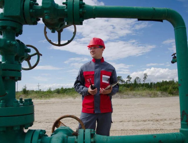 Remote worker inspecting equipment at an oil and gas pumping site