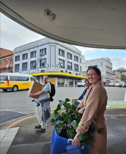 Team members moving boxes into the new Dunedin Petridish shared office space