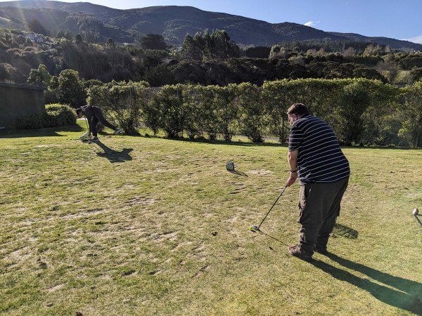 Staff hitting golf balls during the team social afternoon at Otago Golf Club