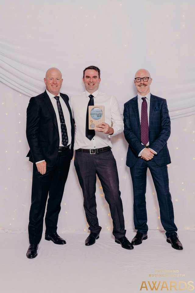 GetHomeSafe team members at the Grand Business South Awards 2022 backdrop