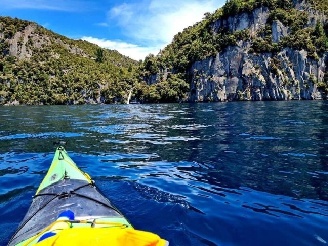 Kayak loaded with gear on the shore of Lake Taupo during the solo paddle
