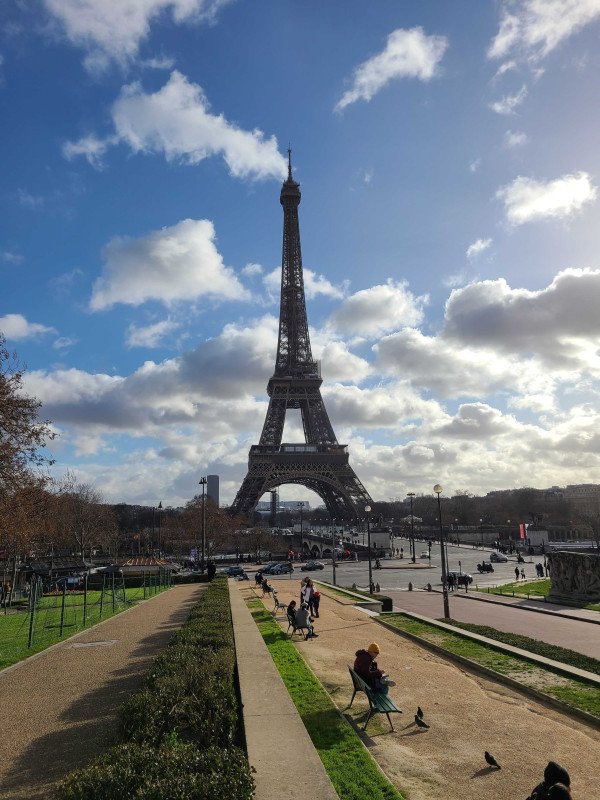 Marc admiring the Eiffel Tower while visiting family in France